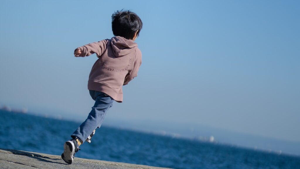 砂浜を走る少年